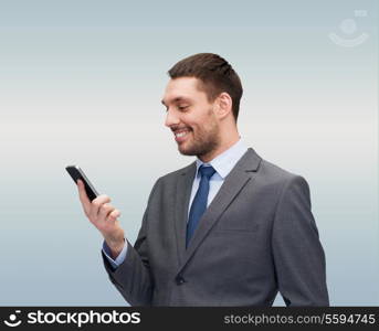 business, technology, internet and education concept - friendly young smiling businessman with smartphone