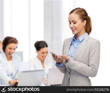 business, technology, internet and education concept - friendly young smiling businesswoman with smartphone