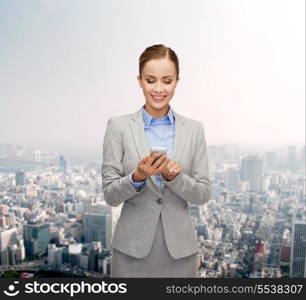 business, technology, internet and education concept - friendly young smiling businesswoman with smartphone