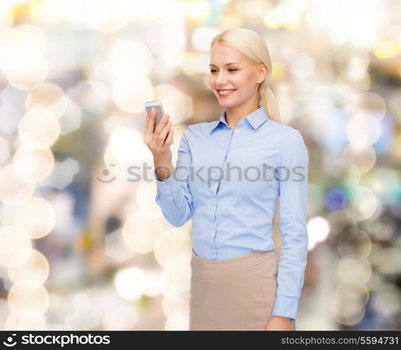 business, technology, internet and education concept - friendly young smiling businesswoman with smartphone