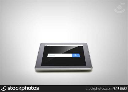 business, technology, internet and modern gadget concept - close up of tablet pc computer with browser search bar on screen gray background