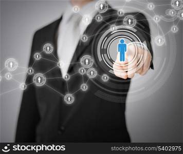 business, technology, internet and networking concept - businessman pressing button with contact on virtual screens