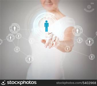 business, technology, internet and networking concept - businesswoman pressing button with contact on virtual screen