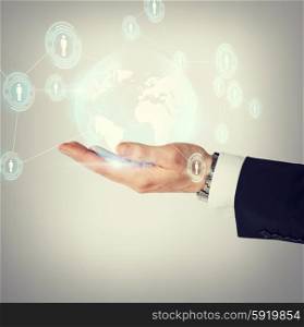 business, technology, internet and networking concept - man hand holding hologram with globe and contacts
