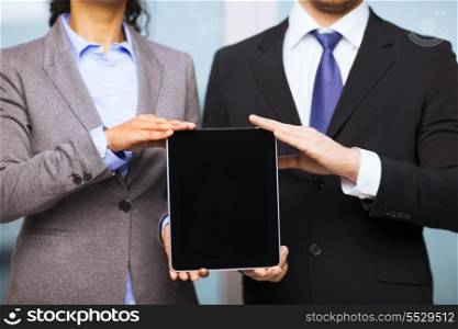 business, technology, internet and office concept - businessman and businesswoman with blank black tablet pc screen in office