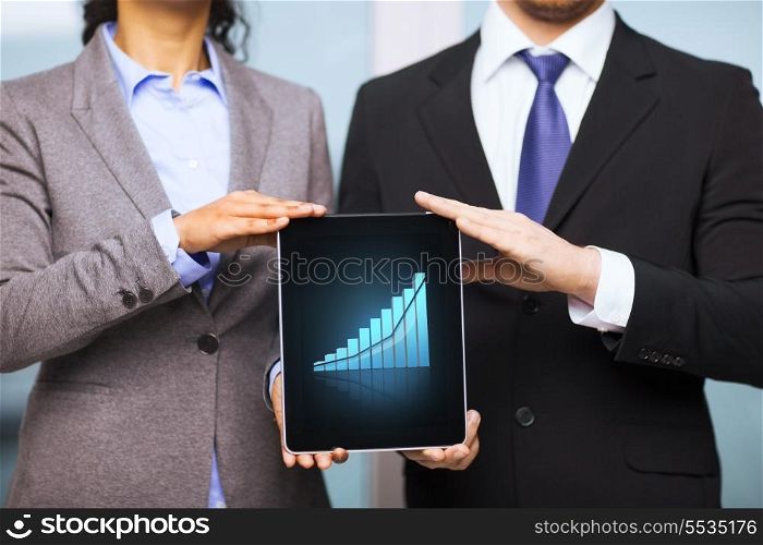 business, technology, internet and office concept - businessman and businesswoman with graph on tablet pc screen in office