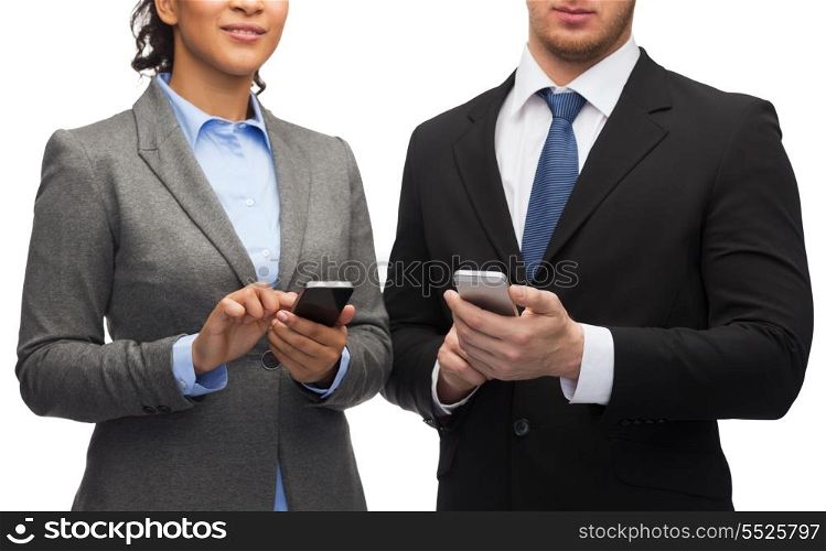 business, technology, internet and office concept - businessman and businesswoman with smartphones
