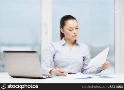 business, technology, internet and office concept - busy, businesswoman with laptop and charts in office