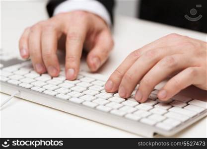 business, technology, internet and office concept - close up of businessman hands working with keyboard