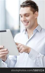 business, technology, internet and office concept - smiling businessman with tablet pc computer in office