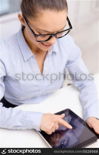 business, technology, internet and office concept - smiling businesswoman in eyeglasses with tablet pc in office