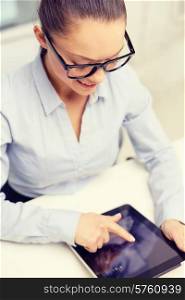 business, technology, internet and office concept - smiling businesswoman in eyeglasses with tablet pc in office