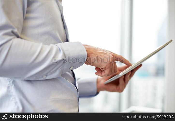 business, technology, internet and people concept - businessman looking to tablet pc computer at office