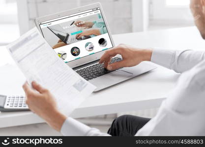 business, technology, internet shopping and people concept - close up of businessman with online shop web page on laptop computer screen working at office