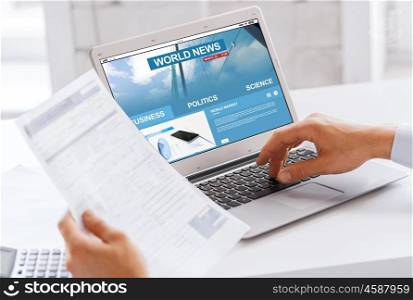 business, technology, mass media and people concept - close up of businessman with internet news on laptop computer screen working at office