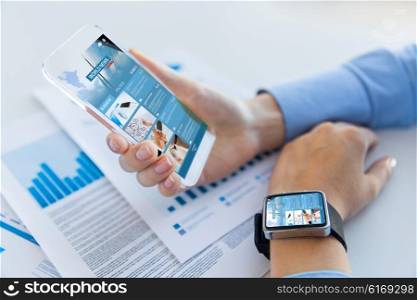 business, technology, mass media and people concept - close up of woman hand holding and showing showing news web page on transparent smartphone screen at office