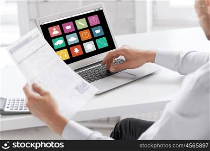business, technology, multimedia and people concept - businessman with menu icons on laptop computer screen working at office