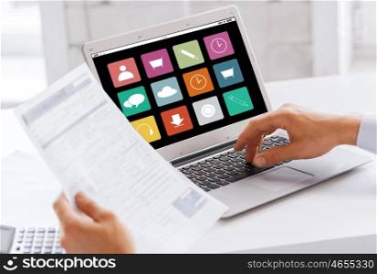business, technology, multimedia and people concept - businessman with menu icons on laptop computer screen working at office