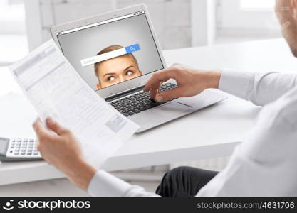 business, technology, multimedia and people concept - close up of businessman with internet browser search bar on laptop computer screen working at office