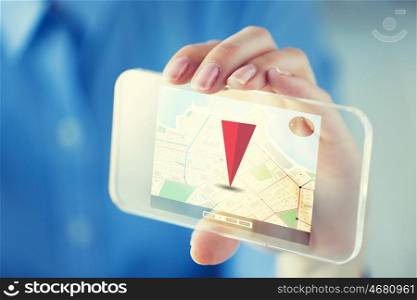 business, technology, navigation and people concept - close up of woman hand holding and showing gps navigator on transparent smartphone screen