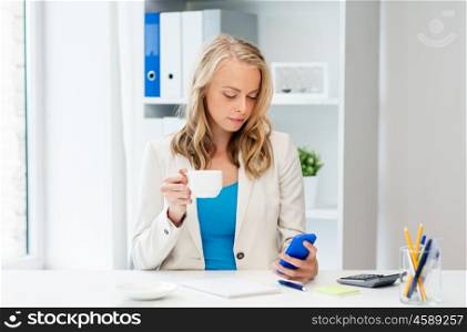 business, technology, people and communication concept - businesswoman texting on smartphone at office