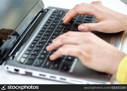 business, technology, school, people and education concept - close up of businesswoman or student girl with laptop computer sitting at table