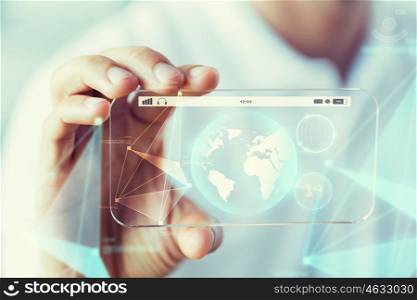 business, technology, science and people concept - close up of male hand holding and showing transparent smartphone earth globe projection
