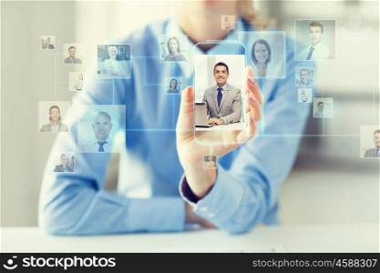business, technology, social network, head hunting and people concept - close up of woman hand holding and showing transparent smartphone with contact icons on screen at office