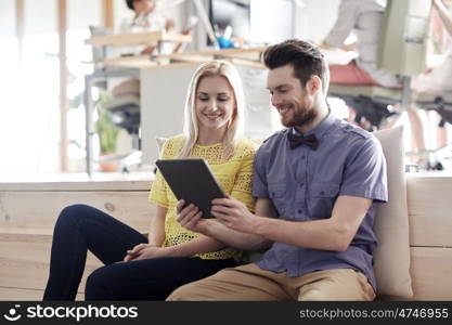 business, technology, startup and people concept - happy creative team with tablet pc computer in office