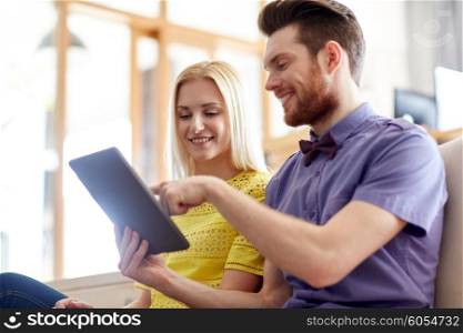 business, technology, startup and people concept - happy creative team with tablet pc computer in office