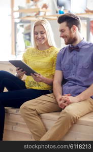 business, technology, startup and people concept - happy creative team with tablet pc computer in office