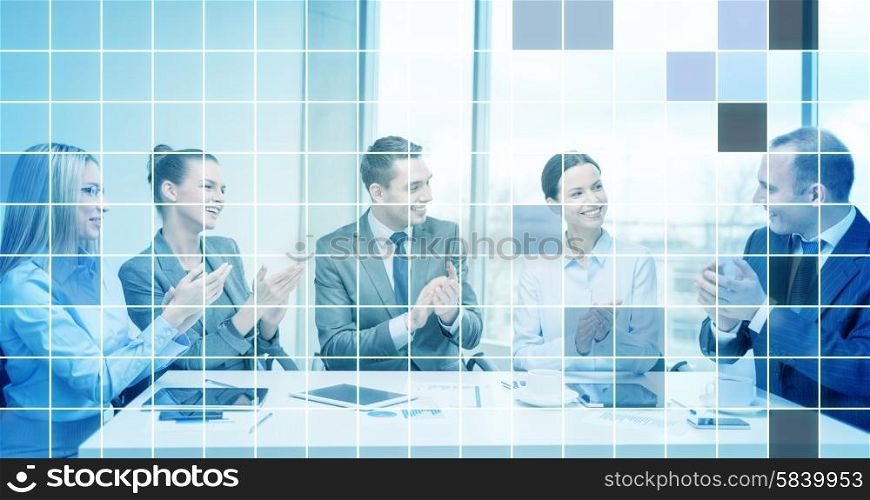 business, technology, success and people concept - happy business team with laptop computers, documents and coffee clapping hand over blue squared grid background