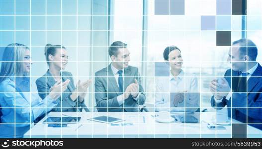 business, technology, success and people concept - happy business team with laptop computers, documents and coffee clapping hand over blue squared grid background