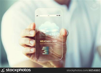 business, technology, weather cast and people concept - close up of male hand holding and showing transparent smartphone with meteo forecast