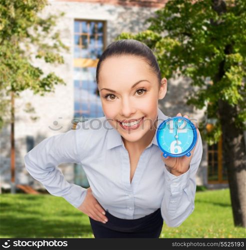 business, time and deadline concept - smiling businesswoman with blue clock
