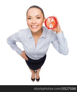 business, time and deadline concept - smiling businesswoman with red clock