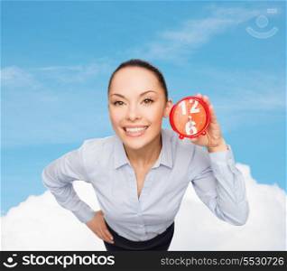 business, time and deadline concept - smiling businesswoman with red clock