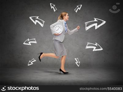 business, time and education concept - smiling young businesswoman with clock running