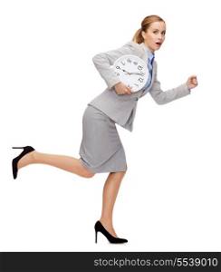business, time and education concept - stressed young businesswoman with clock running