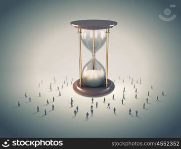 Business time. Conceptual image with sandglass and silhouettes of business people around