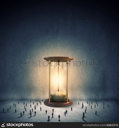 Business time. Conceptual image with sandglass and silhouettes of business people around