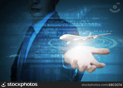 Business travel. Close up of businessman at digital background with airplane in palm