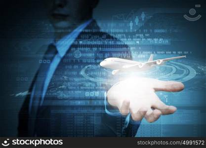 Business travel. Close up of businessman at digital background with airplane in palm