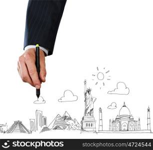 Business travel. Close up of businessman hand sketching images