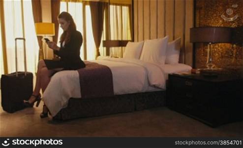 Business travel, people traveling, working in hotel room, manager. Caucasian businesswoman, girl, woman at work, using smartphone, mobile phone, telephone for email, internet. Career, success. 5of21