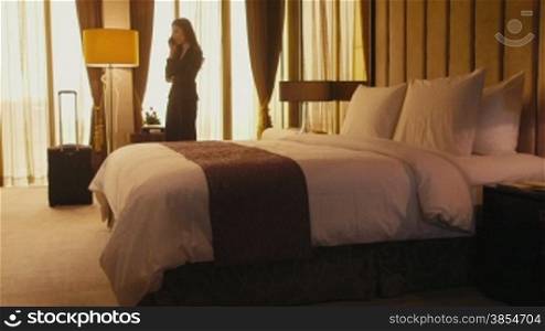 Business travel, people traveling, working in hotel room, manager. Asian businesswoman, girl, woman at work, talking on cell phone, mobile telephone. 19of21