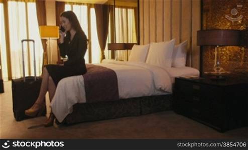 Business travel, people traveling, working in hotel room, manager. Asian businesswoman, girl, woman at work, talking on cell phone, mobile telephone. Career and success. 9of21