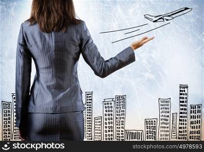 Business travel. Rear view of businesswoman with travel sketch at background