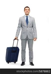 business trip, traveling, luggage and people concept - happy businessman in suit with travel bag