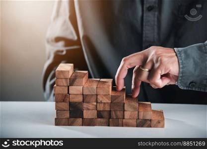 Business two finger symbol walking up on wood blocks shape staircase to climb up career ladder step up stair growth success, prevent collapse or crash concept